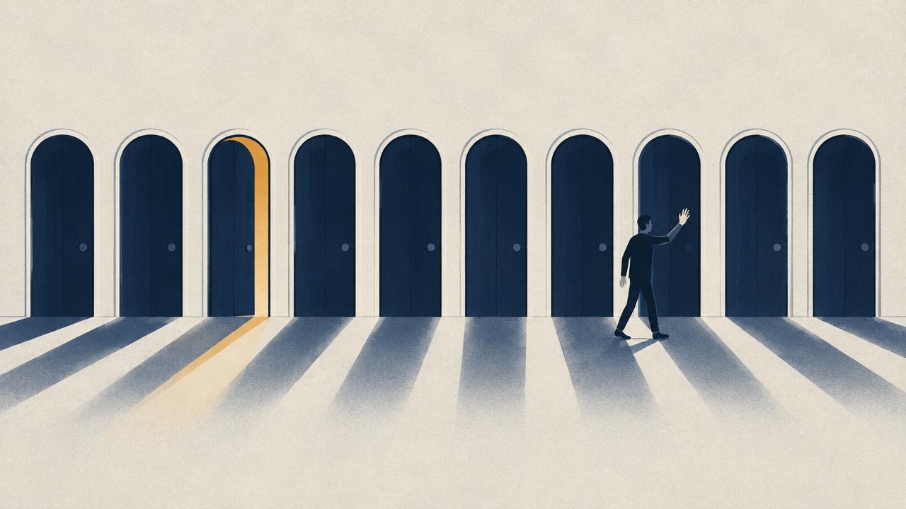 A row of narrow gateways crossing the frame, most shut and dark, one open with a thin amber light